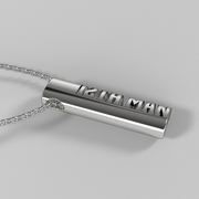 Silver oval pendant with vertical ‘12th Man’ lettering shown laying on its side.